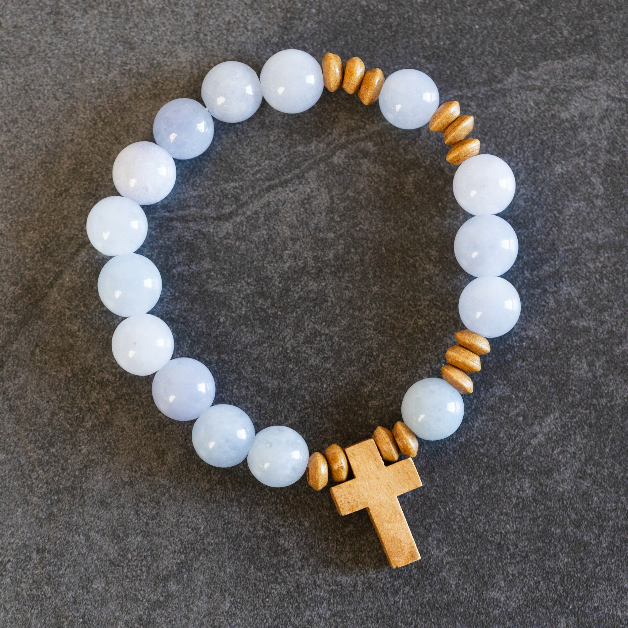 Bracelet stretch w/cross charm stn/wd lt blu/brn