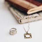 Ring crossing spiral bombshell .5W silver/brass